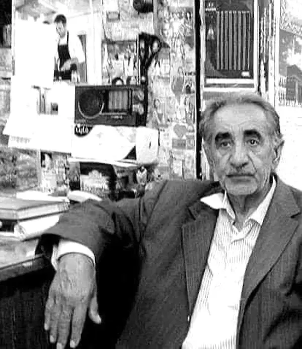 Man in an office surrounded by writing tools